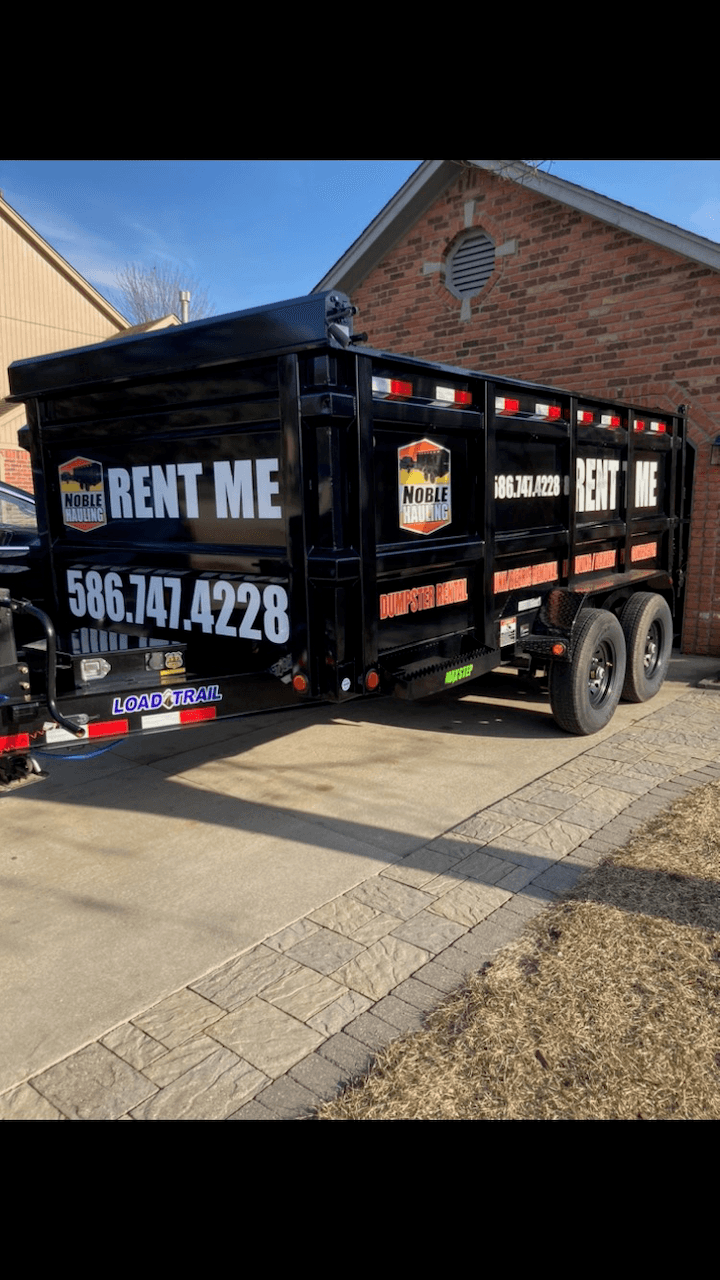 Side view of a Noble Hauling 15 Yard Dumpster.